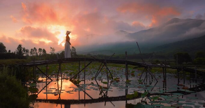 Vietnam Sunrise Calm At Tra Ly Lotus Pond With Woman On Bamboo Bridge