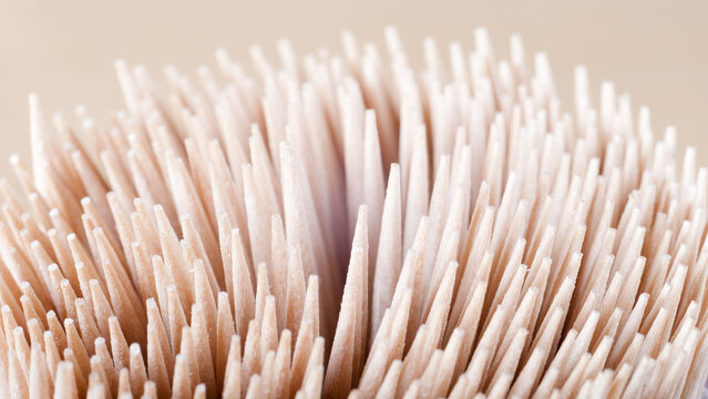 The photo shows a close-up of a wooden toothpick