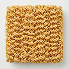 A square block of air-dried instant ramen noodles with a golden-brown color