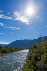 Obraz premium Scenic view from bridge between Ascona and Locarno with Maggia River and Lago Maggiore lake in the background on a sunny summer day. Photo taken September 3rd, 2025, Ascona Locarno, Switzerland.