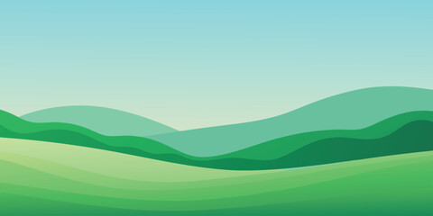 Fototapeta premium A summer nature landscape with green hills and mountains under a blue sky with white clouds and a bright horizon