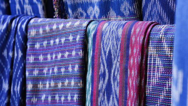 Close-up images of local fabric patterns displayed at tourist attractions in Thailand.