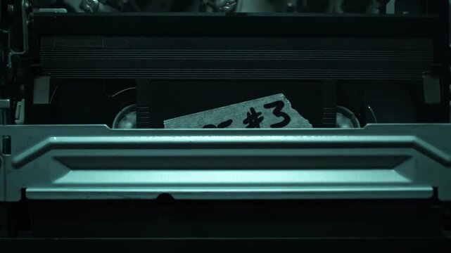 Inserting VHS Tape - Video Cassette Being Pushed into the VCR, the Tape Transport Mechanism in Macro - Smoky Interrogation Room