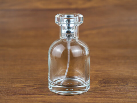 An empty perfume bottle isolated on wooden texture background