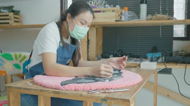 A focused individual works on a colorful handmade textile project in a cozy workshop, showcasing creativity and craftsmanship. The scene emphasizes the importance of art and personal expression in cra