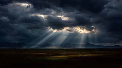 Dramatic storm sky sunbeam over moorland and distant mountain range, moody light breaking through clouds creating atmospheric contrast