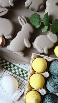 Enjoyable Easter pastime involving eggs and bunny-shaped molds on the kitchen table during the springtime.
