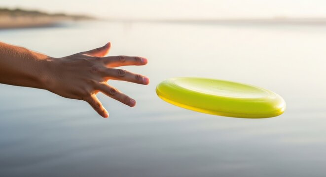 Hand throwing frisbee over calm water surface, adult hand reaching out to throw frisbee disk toward distant horizon. Concept throwing frisbee for summer leisure, outdoor activity, or recreation.