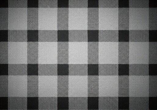 Classic woven texture showing a subtle checkered pattern of dark and light gray plaid fabric as a seamless background, backdrop, woven, subtle
