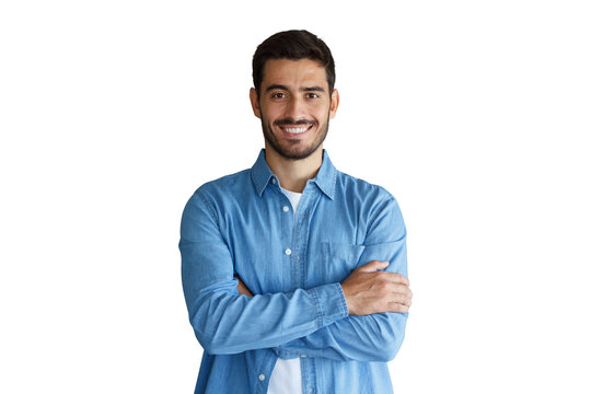 Confident young man in blue denim shirt standing with arms crossed and smiling broadly