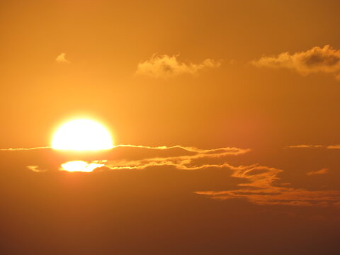 Beautiful Orange Sky Sunrise / Sunset through clouds