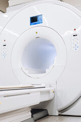 Modern MRI or CT scanner in hospital radiology department. Advanced medical technology concept
