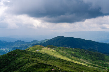 Fototapeta premium Rolling Green Hills and Winding Roads Through Mountain Landscape