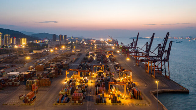 Lighted Container Harbor Port at Dusk with Industrial Cranes and Cargo