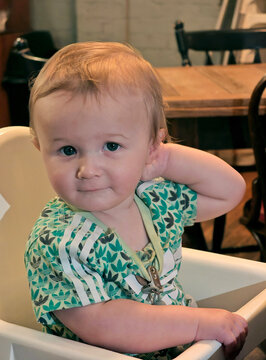 baby boy looks quizzically at camera