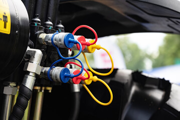 Close-up of hydraulic connectors and valves on industrial equipment.
