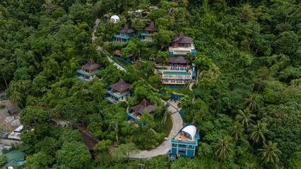 Drone aerial view of Karuna villas on the mountain near Corong Corong next to El Nido, The Philippines. © Roger