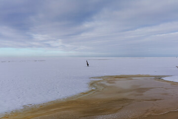 Minimalist winter seascape with frozen shore