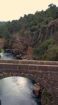 Oluk stone bridge in Koprulu canyon over K&ouml;pr&uuml;&ccedil;ay river, drone video, Manavgat, Antalya, T&uuml;rkiye.	