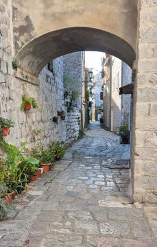 Medieval cobbled street and archway, Perast, Montenegro