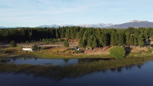 Aerial drone views of Laguna Zeta near Esquel, Patagonia, featuring pristine mountain lake scenery and camper vans parked in peaceful wilderness