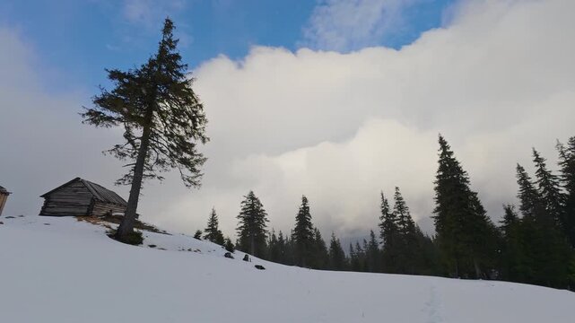 Rustic Abandoned Cabins in Snowy Mountain Landscape