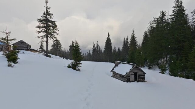 Rustic Abandoned Cabins in Snowy Mountain Landscape