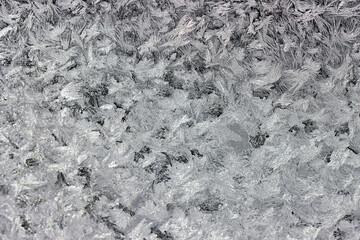 Intricate frost pattern on a window on a negative temperature day in winter.