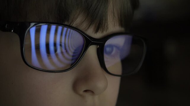 Child Boy With Glasses Watching Hypnotic Screen. Influence of Media on People. Broadcast False Information, Hoax, Propaganda Brainwashing Disinformation. Manipulation Crowd Fakes, False Information.