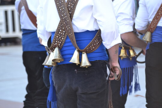 Traditional festival attire featuring bells and sashes in colmenar viejo. Spanish traditions, folk festival