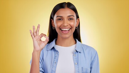 Smiling Person Making OK Hand Gesture on Yellow Background