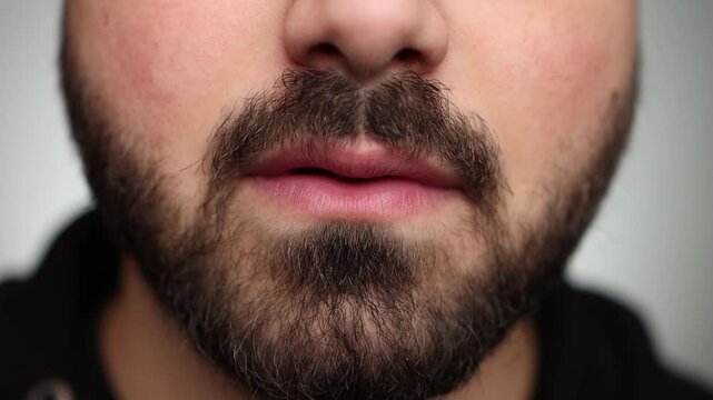 Close up of a man fidgeting with his mouth. Mouth fidgeting. Mouth movement