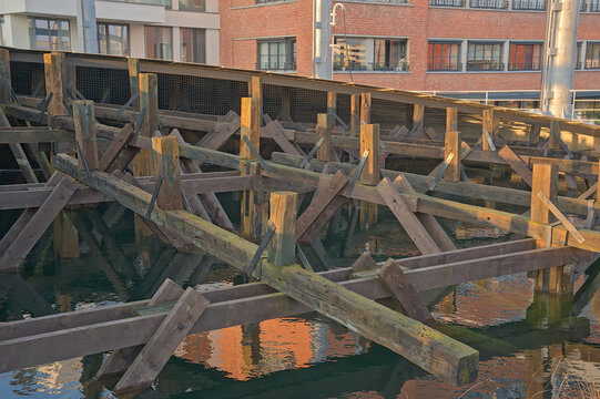 wooden structure supporting an old gas tank. Restored industrial heritage on Tondelier site, Ghent, Flanders, Belgium 