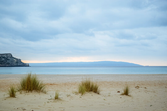 Simos Beach, Elafonisos, Greece: Sandy beach with grass and distant cliffs