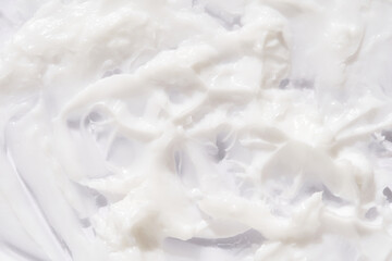 Creamy white texture background with smooth swirls for skincare and beauty product mockups.