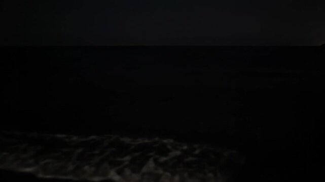 Ocean Waves Reflecting Moonlight Under Starry Sky