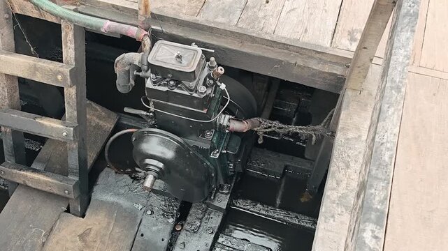 Old diesel engine powering a wooden boat
