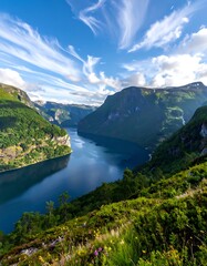Fototapeta premium Valley view with a fjord under an open sky, framed by green slopes and lush vegetation in foreground