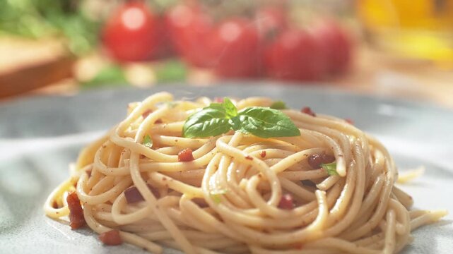 Placing Basil Leaf with Tweezers onto Freshly Cooked Spaghetti Carbonara Served on a Bright Plate in the Restaurant, Dolly out, Slow Motion