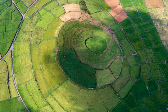 Aerial view of Terceira islans in Azores, Portugal. Volcanic landscape.  Drone shot of ancient Pico Dona Joana volcano and  cabras islet. Green fields in rural environment.