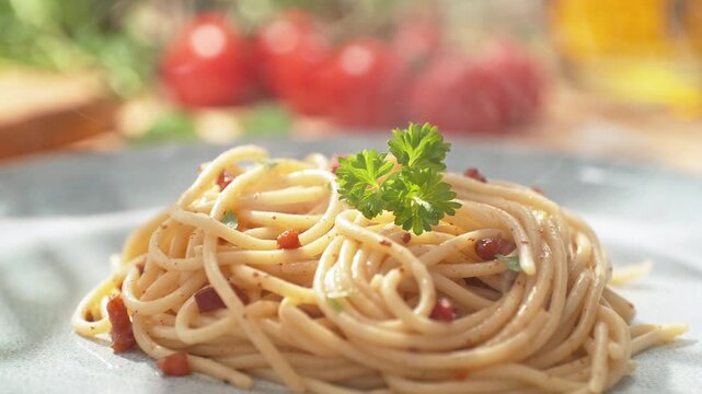Decorating Spaghetti Carbonara with Parsley - Freshly Prepared Steaming Dish on a Bright Plate in the Kitchen, Dolly out, Slow Motion