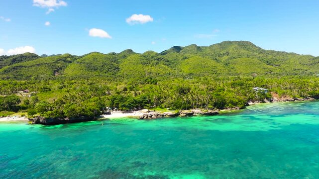 Coast with a sandy beach and azure water surrounded by a coral reef. Bohol, Anda, Philippines. Summer and travel vacation concept.