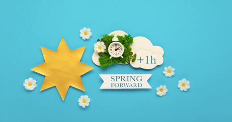 Fototapeta premium Daylight saving Time, Spring forward, Summer back concept. White Alarm Clock and Spring Daisy Flowers on Blue Background