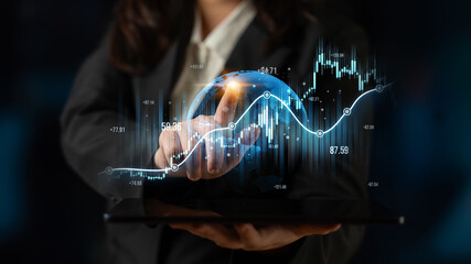 A business professional interacts with a 3D globe and financial data on a tablet, showcasing the...