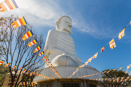 White Buddha seated on a lotus base in Linh Ung Pagoda, Ba Na Hills, Vietnam