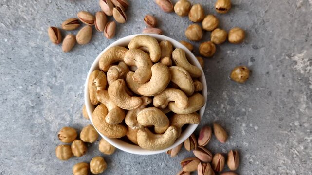Roasted or raw cashews make a savory snack for a healthy, filling meal. Cashews as a food background for your design