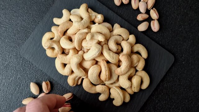 Roasted or raw cashews make a savory snack for a healthy, filling meal. Cashews as a food background for your design
