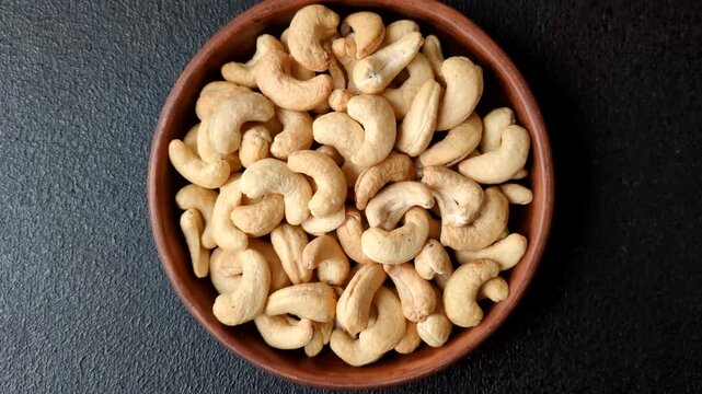 Roasted or raw cashews make a savory snack for a healthy, filling meal. Cashews as a food background for your design