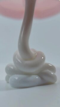 Melting beauty cream. Close up vertical shot for beauty concept. Beauty cream liquid.