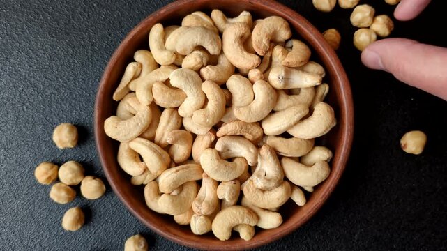 Roasted or raw cashews make a savory snack for a healthy, filling meal. Cashews as a food background for your design